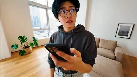 AI Video from prompt: A realistic young person standing indoors, holdi