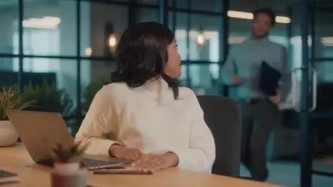 AI Video from prompt: A girl is sitting in an office and a young guy e