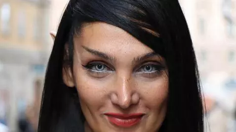 AI Video from prompt: woman looking at camera and blinking her eyes