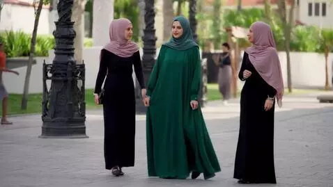 AI Video from prompt: Two women with hijab and one of black long tight