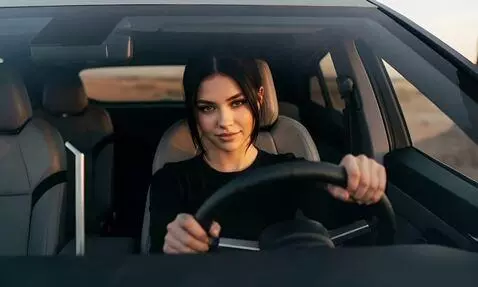 AI Video from prompt: The shot starts with a female driver in the cabi