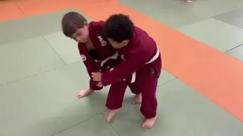 AI Video from prompt: two boys at six years,wearing burgundy bjj jacke