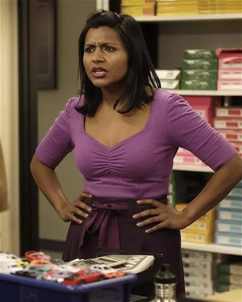AI Video from prompt: A snooty Indian-American office worker is standi