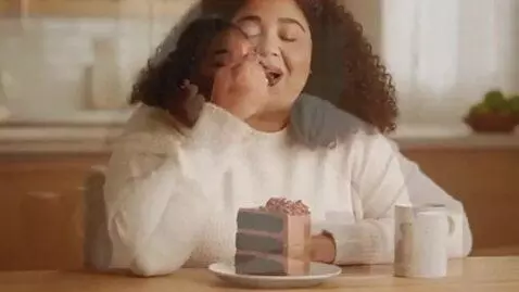AI Video from prompt: girl starts eating cake and gains 50 pounds and 