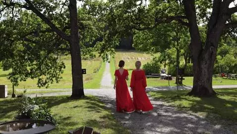 AI Video from prompt: two women in red dresses walking