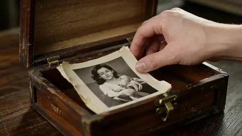 AI Video from prompt: close—up of a hand carefully placing a photo in 