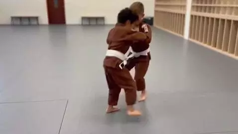 AI Video from prompt: two boys at six years,wearing brown bjj jackets,