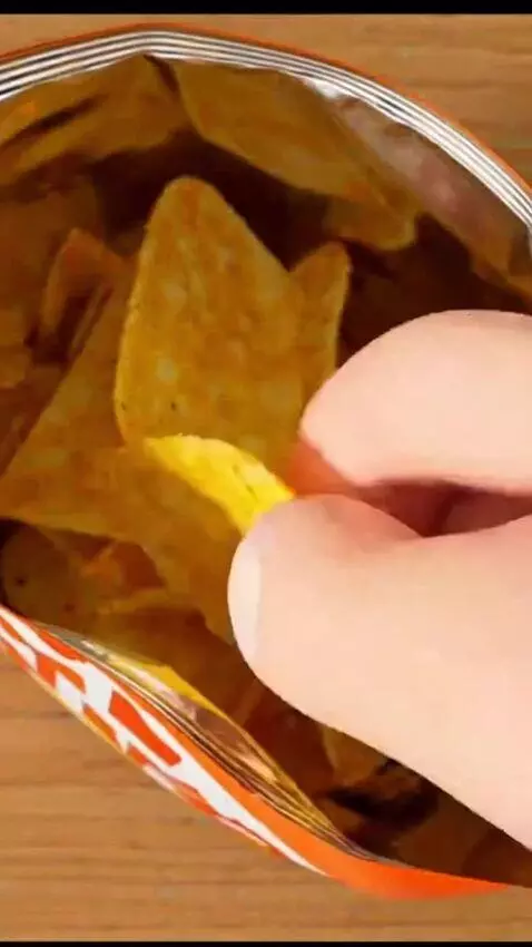 AI Video from prompt: Image1 eat a pack of chips.