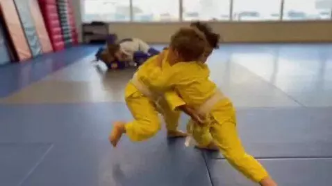 AI Video from prompt: two boys at six years,wearing yellow bjj jackets