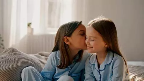 AI Video from prompt: Two Kid Girls Wearing Blue Pajamas And Kissing