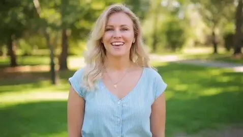 AI Video from prompt: A blonde woman wearing a bikini looks at the cam