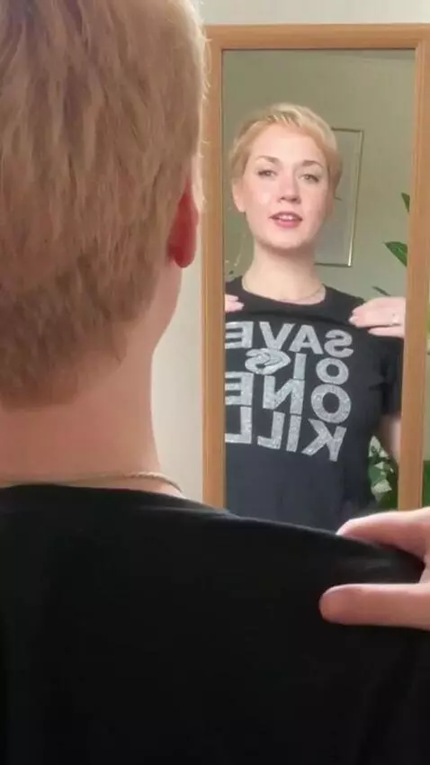 AI Video from prompt: A girl tries on a T-shirt