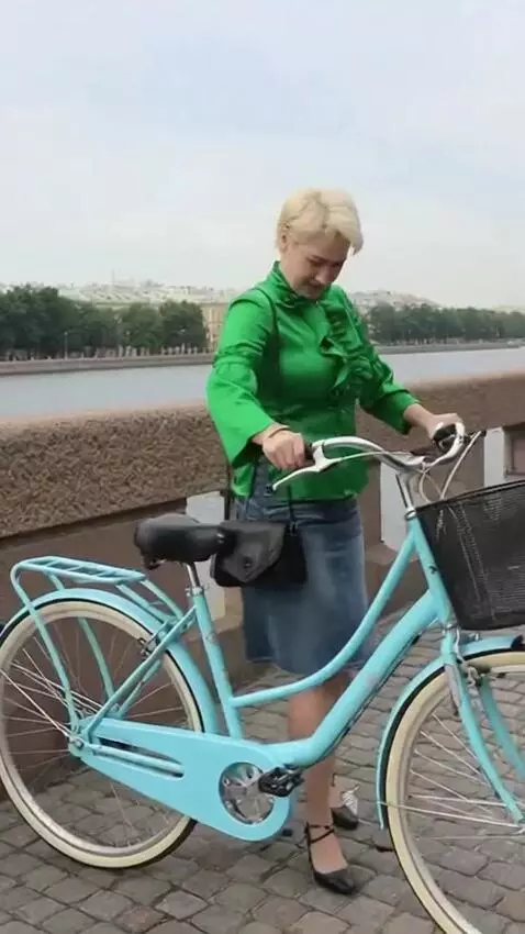 AI Video from prompt: The girl in the short skirt gets on the bicycle