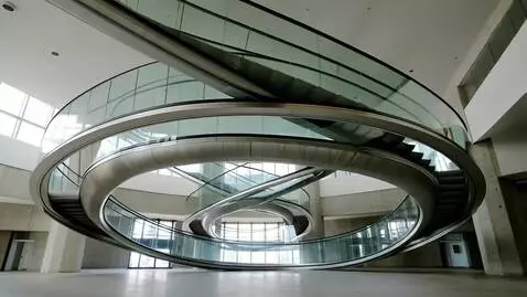 AI Video from prompt: Intersecting circular escalators. Enormous rings