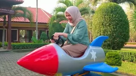 AI Video from prompt: Faiza Fitria riding the Rocket jet kiddie ride (