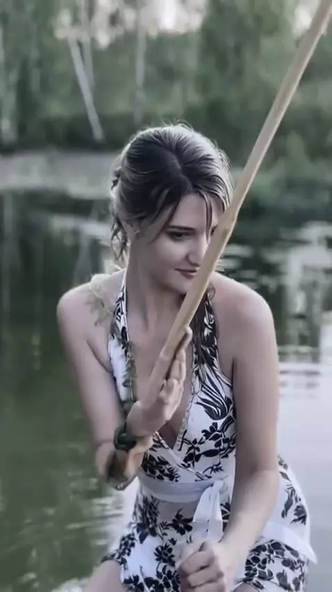 AI Video from prompt: The girl is hunting fish with a spear.