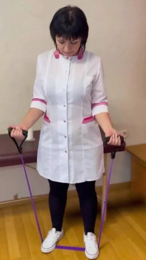 AI Video from prompt: The woman steps on a fitness band and does the e