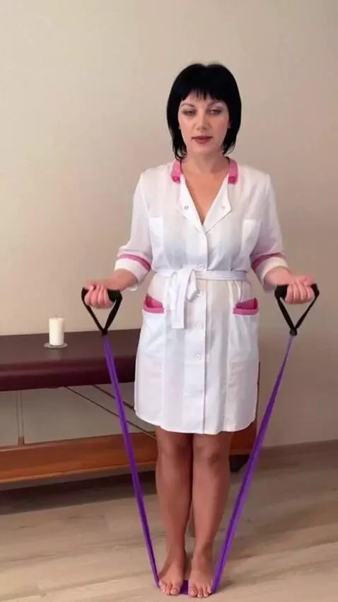 AI Video from prompt: A woman in a short robe steps on a fitness band 