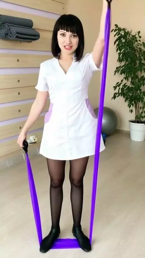 AI Video from prompt: The woman stands on the fitness band, raises her