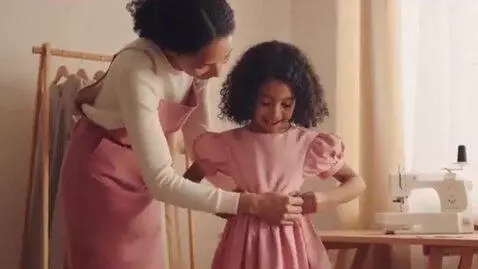 AI Video from prompt: Woman shrinks her dress to fit her daughter it