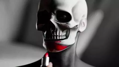 AI Video from prompt: Skull faced model putting on red lipstick
