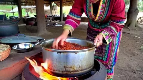 AI Video from prompt: African beans seller cooking her beans fr next m
