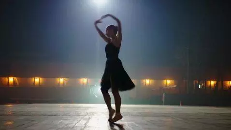 AI Video from prompt: A dancer moves in place with ballet-inspired ste