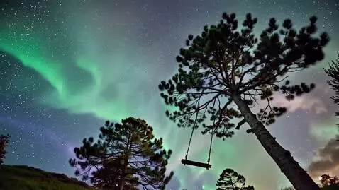 AI Video from prompt: Watching the northern light from a swing hanging