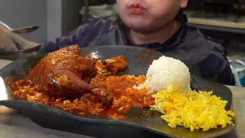 AI Video from prompt: Video of me eating jollof rice and turkey