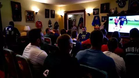 AI Video from prompt: Football lovers watching an on going game inside