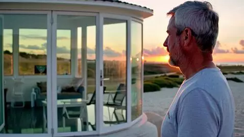 AI Video from prompt: A married man with grey hair watching the sunset