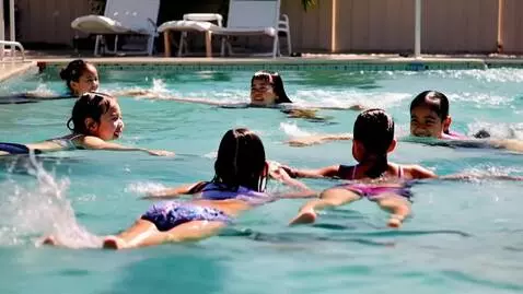 AI Video from prompt: A group of young girls swimming in a pool