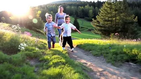 AI Video from prompt: Two toddler boys running with their dogs down a 