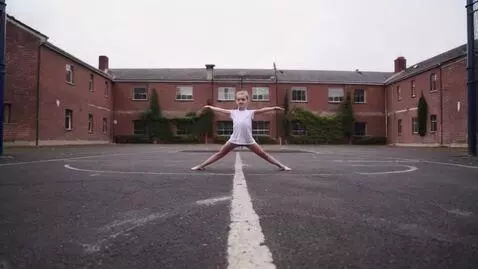 AI Video from prompt: A young  girl stands centered in a typical UK sc