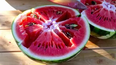 AI Video from prompt: Juicy Watermelon Wedging:**   "Close-up ASMR of 