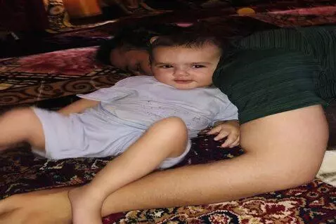 AI Video from prompt: Child stands up and wakes up the man