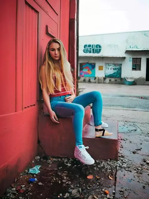 AI Video from prompt: A young woman with long blonde hair sitting on a