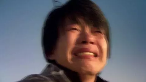 AI Video from prompt: A person looking up with tears, then smiling wit