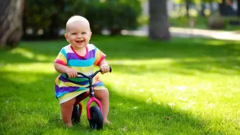 AI Video from prompt: A cute baby wearing colorful clothes happily cyc