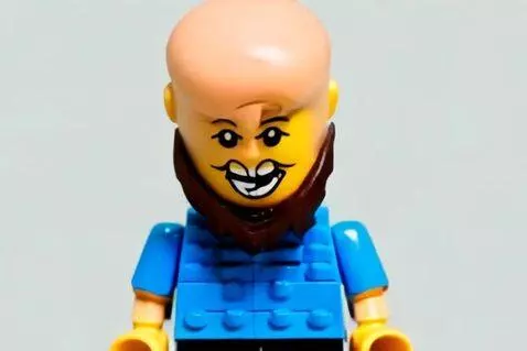 AI Video from prompt: In a stop-motion LEGO universe, a bald-bearded m