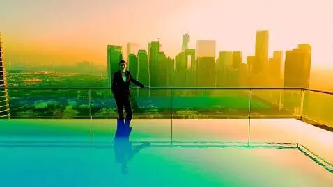AI Video from prompt: Aerial IMAX-grade cinematic shot — rooftop infin