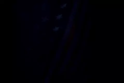 AI Video from prompt: V for vendetta, waving American flag, and a dark