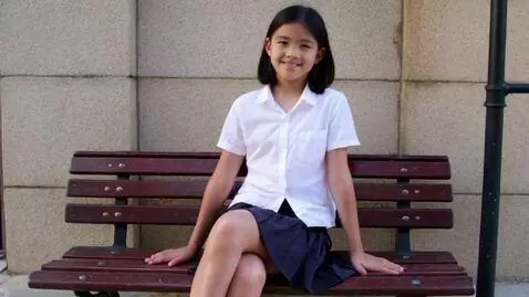 AI Video from prompt: black teen sits on a bench in a skirt