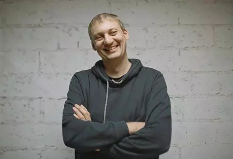 AI Video from prompt: A man stands in front of the camera smiling, the