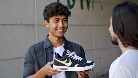 AI Video from prompt: A young guy proudly flexes his sneakers in a cas