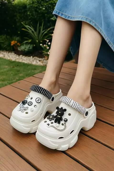 AI Video from prompt: Side-to-front pan shot of FENTINA sandals worn o