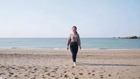 AI Video from prompt: beautiful asian woman walking, smiling at viewer