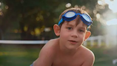 AI Video from prompt: boy 10 yr wearing speedo