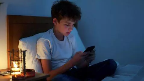 AI Video from prompt: A teenage boy sitting alone in his room, looking