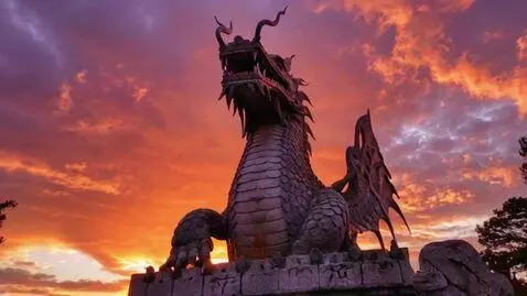 AI Video from prompt: A massive stone dragon statue looms against a fi